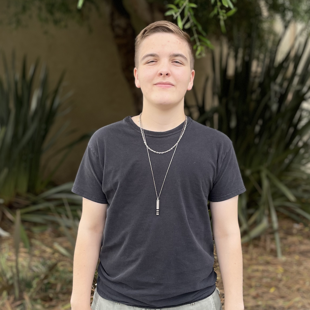 Lyn posed in front of a plant