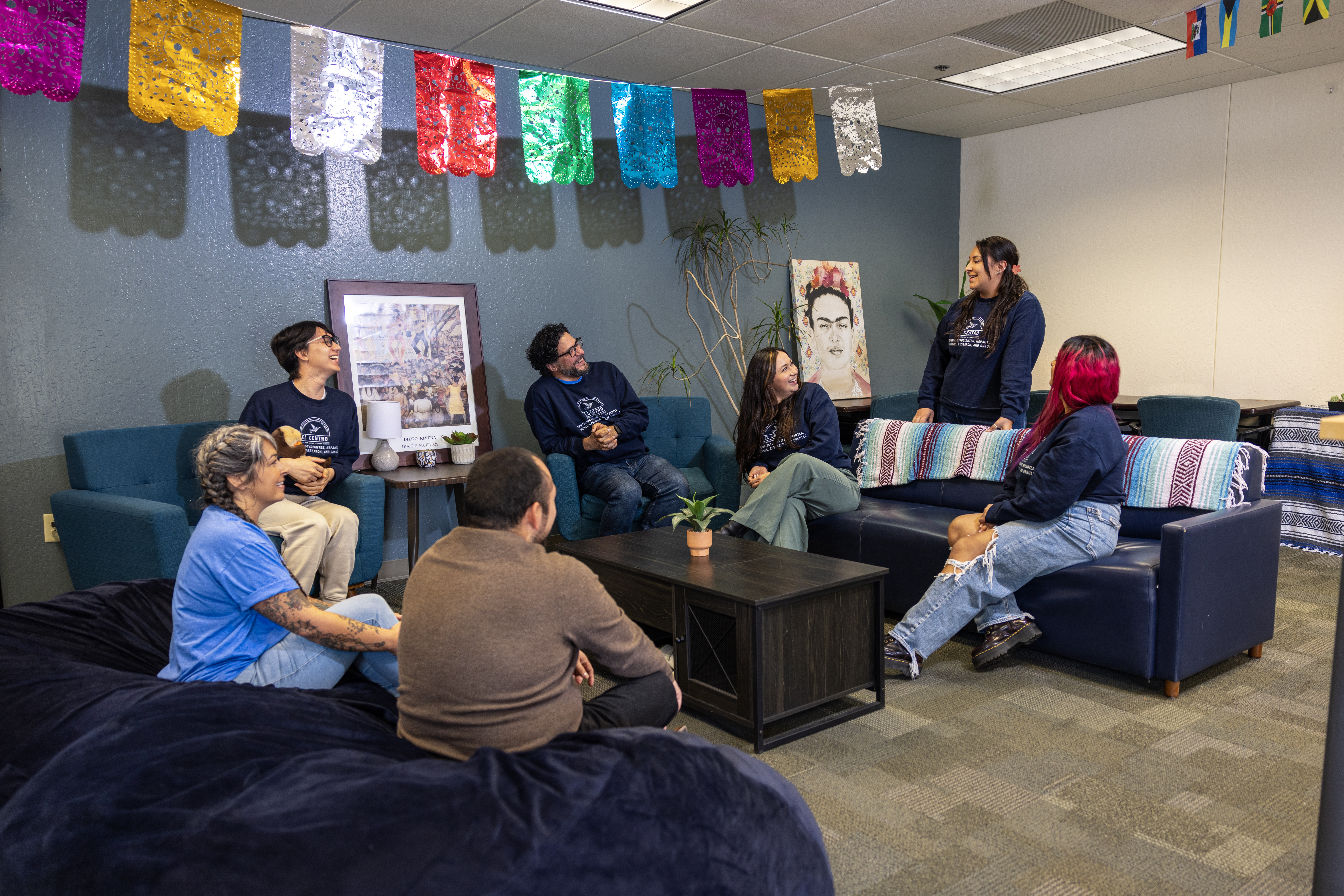 Picture of Latine student and professional staff sitting in a circle