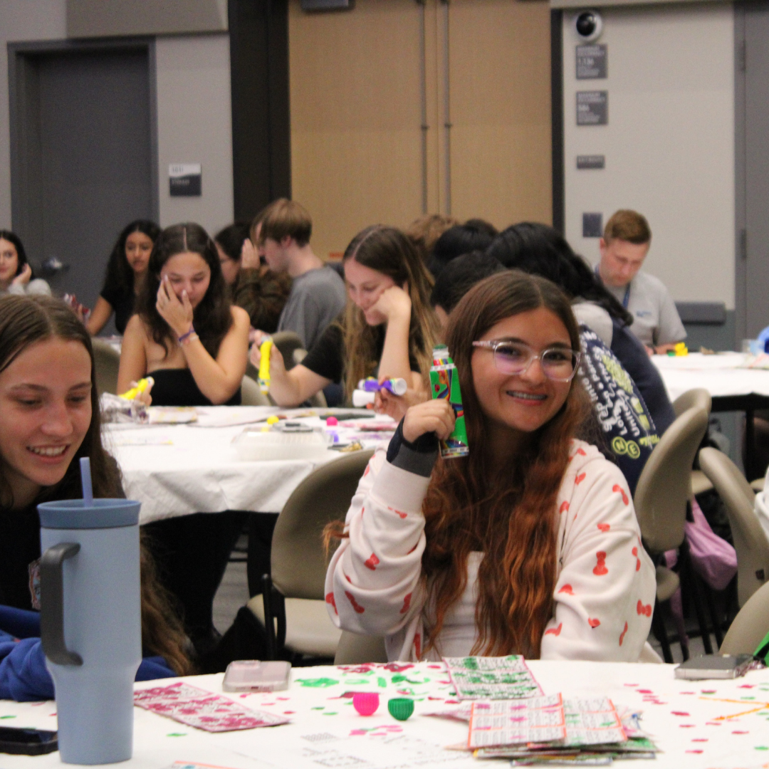 A student holding a stamp stick playing bingo
