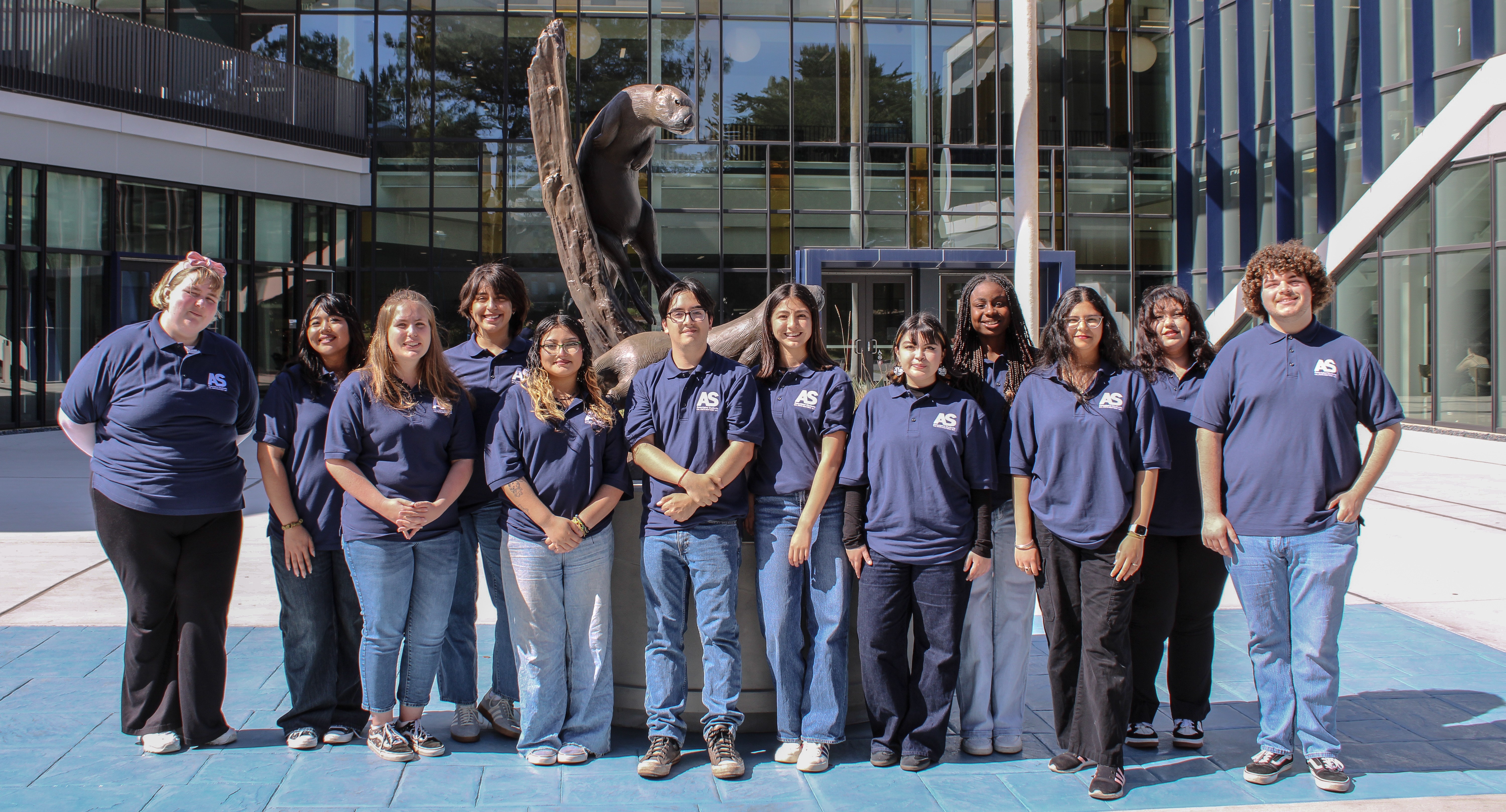 Banner image of all 2025 Fall AS Officers standing in front of Otter Statue