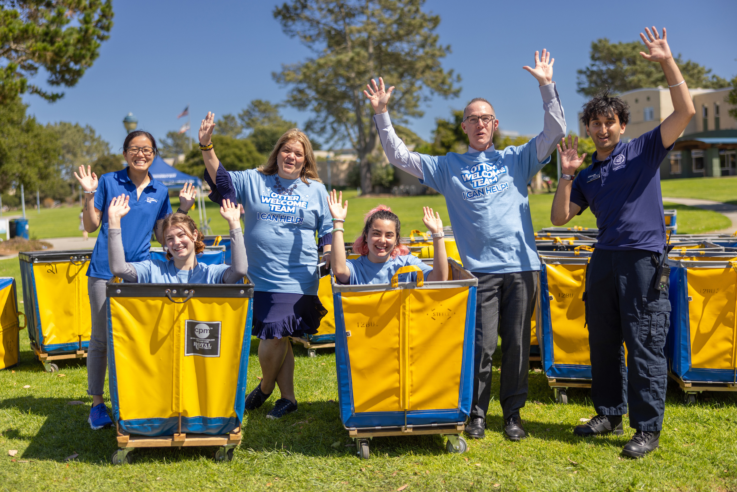 Otter Welcome Team and Housing Staff with there hands up.