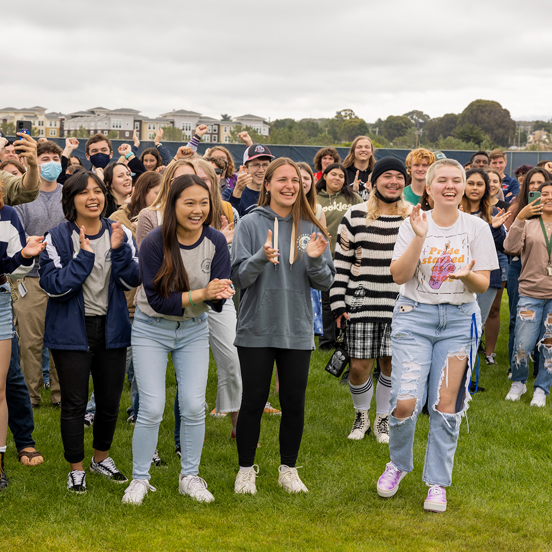 A large group of students clapping in excitement.