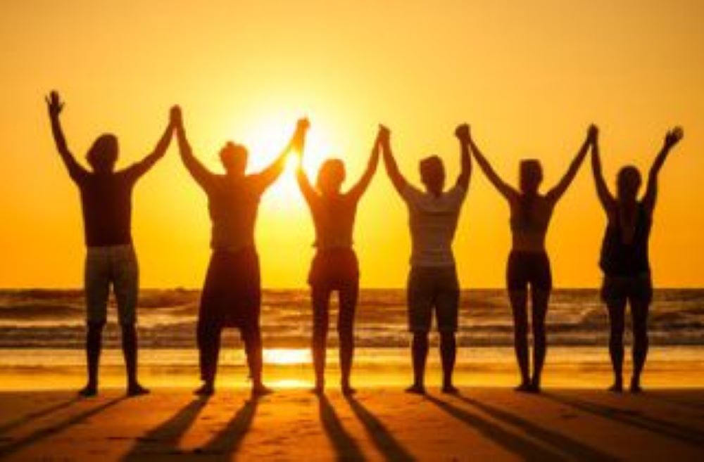 Group of people hodling hands.