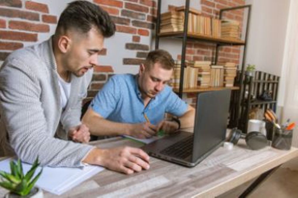 Two people looking at a computer.