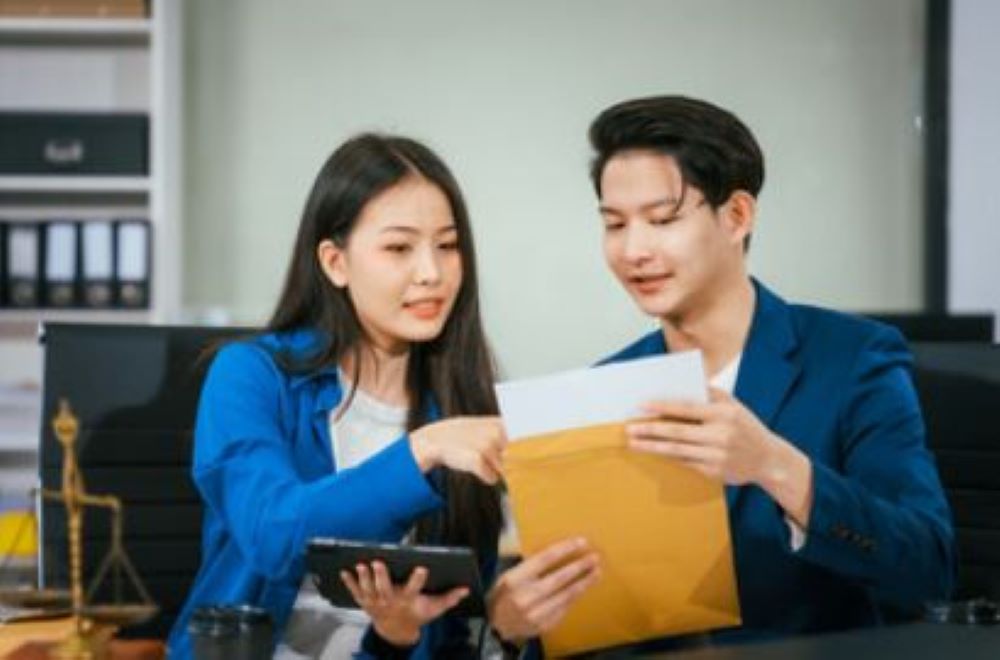 Two people reading a document.
