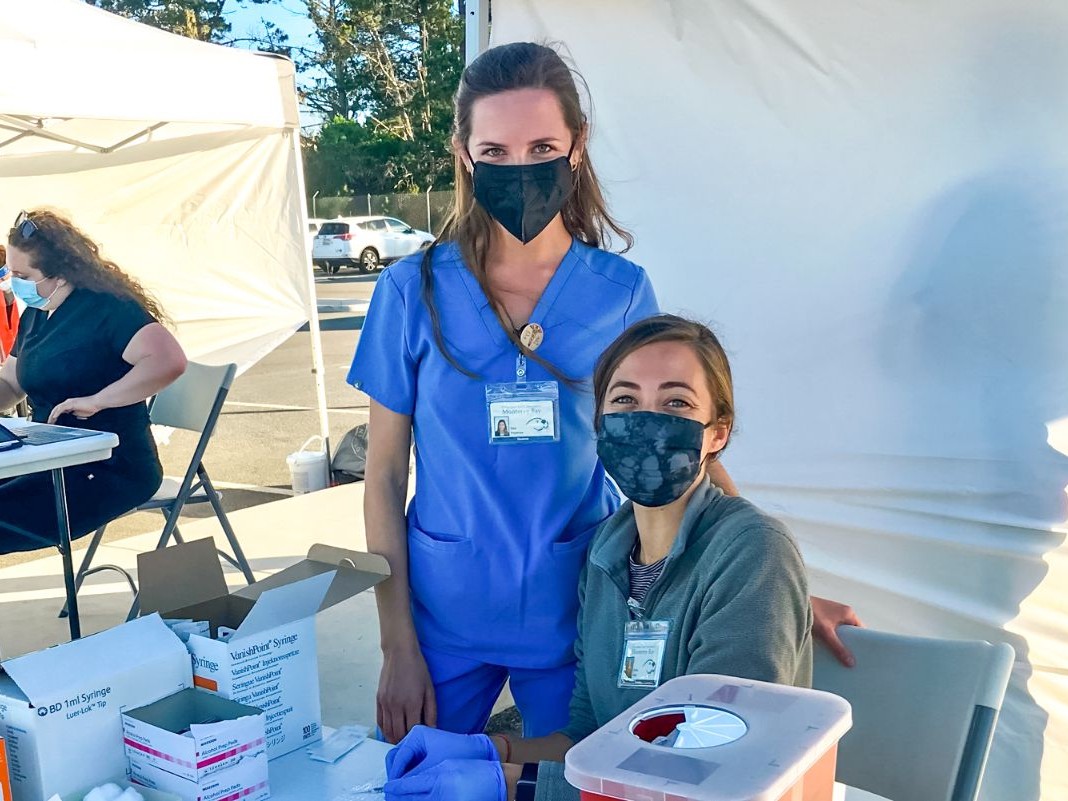 Two nurses at vaccine booth