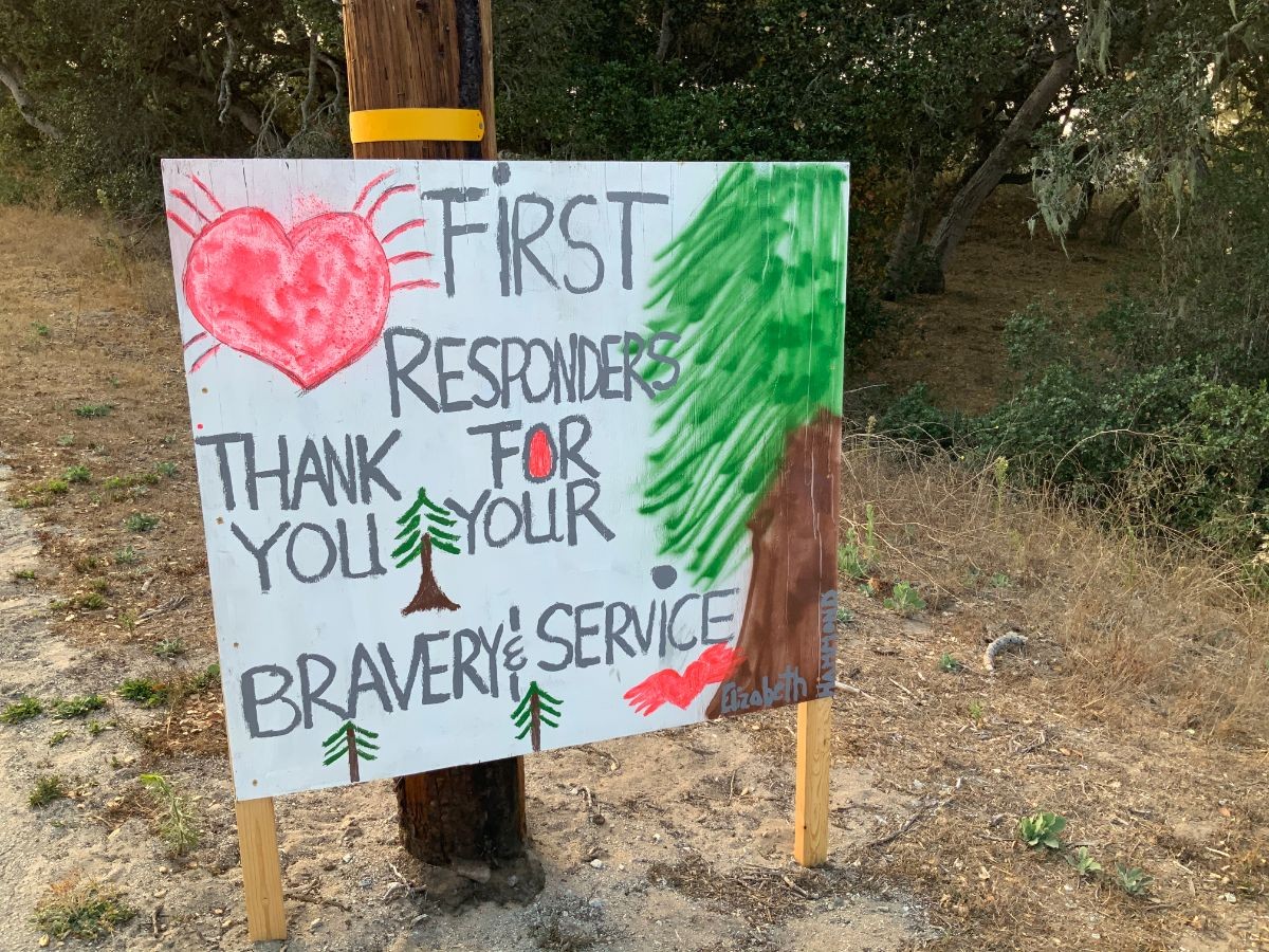 Kids from Girl Scout Troop 32096, some of whom have family who are firefighters, made roadside signs thanking those fighting the fires.