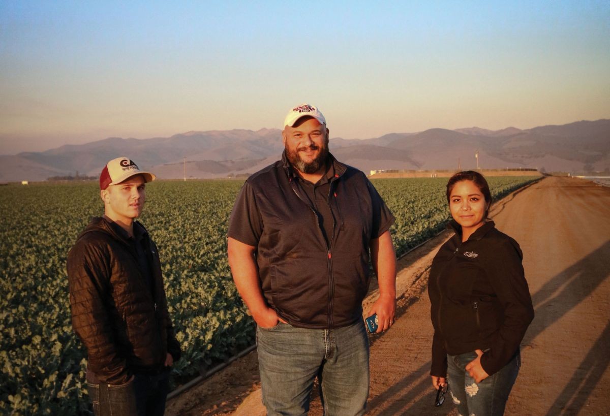 HeavyConnect employees standing by a customer's broccoli field in Salinas.