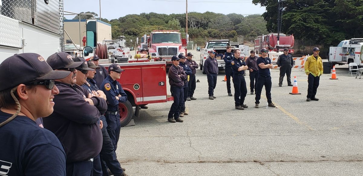 CAL-Fire firefighters assembled at a CSUMB parking lot.