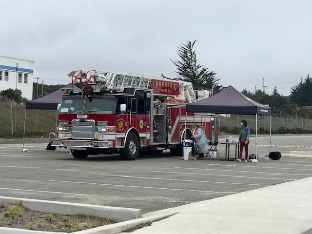 Ana Hernandez thought to bring a step stool to the drive-thru flu shot clinic, which came in handy when this fire engine arrived for firefighters to get shots.