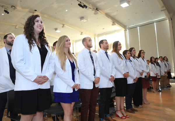 Students in the Master of Science Physician Assistant (MSPA) Program at CSUMB, shown here at their first White Coat Ceremony in December 2019, have joined hospital volunteer corps all over the country to help battle COVID-19.