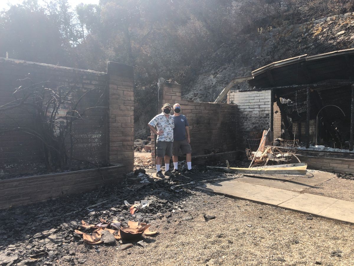 Kevin and Chip at the front of their house after the fire