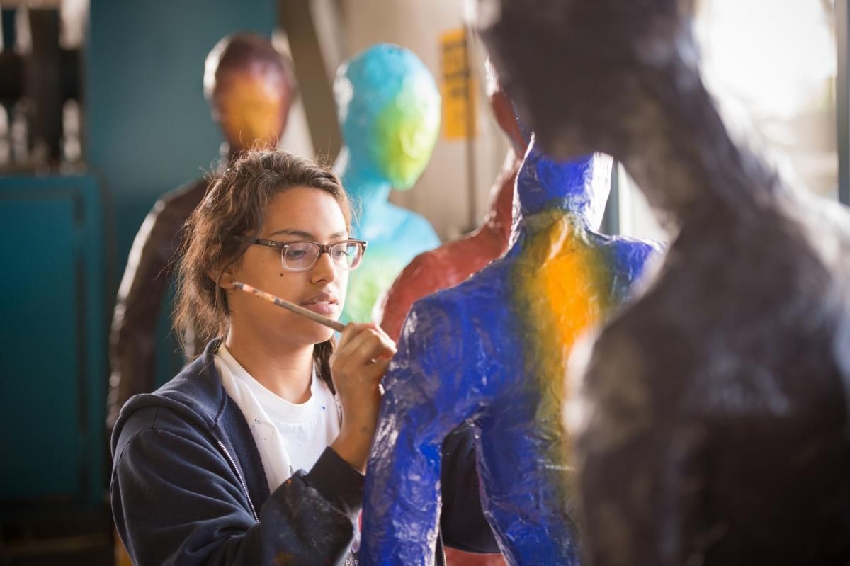 Art student working on capstone sculpture