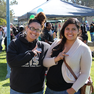 Two students at a CSUMB event smiling for the camera
