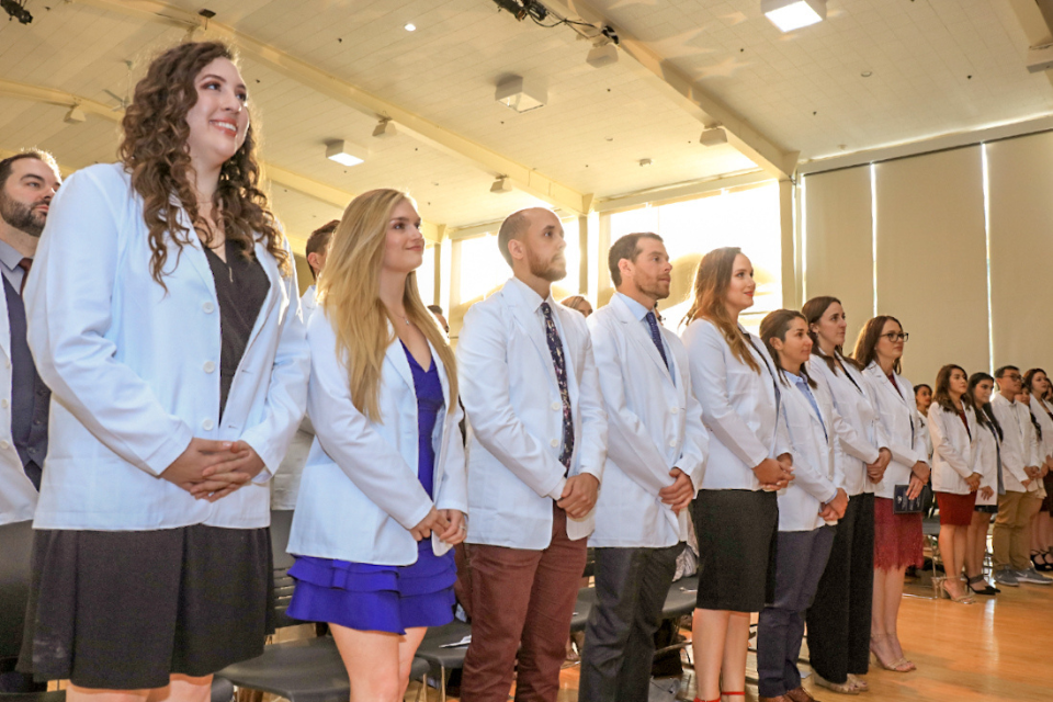 Students standing next to each other at the White Coat Ceremony in CSUMB's Physician's Assistant program
