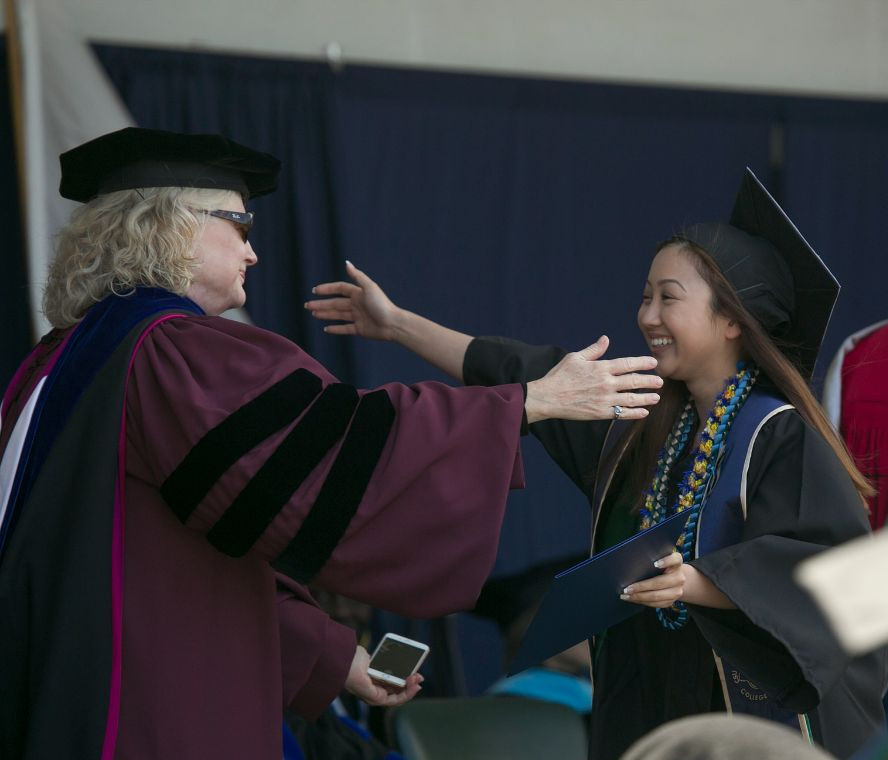 Faculty member and student during 2016 commencement ceremony.
