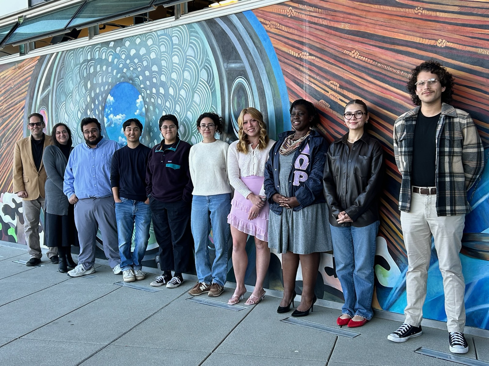 Fall 2024 Debbie Juran Award Recipients standing against mural