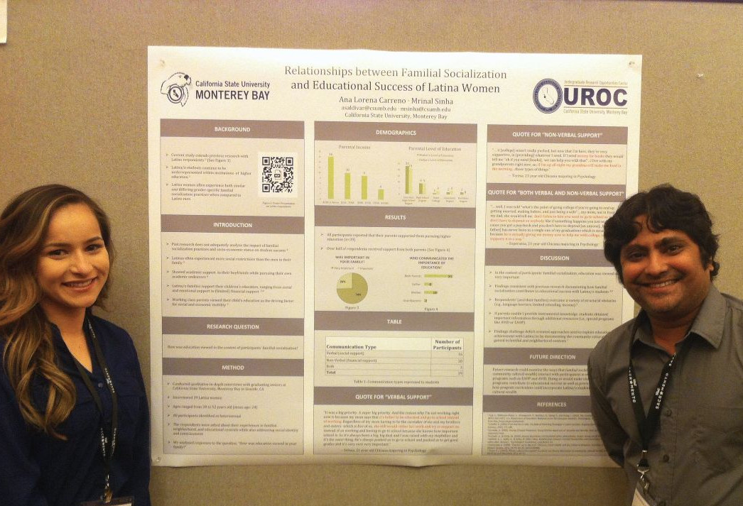 Dr. Sinha and a student standing in front of a research poster at a conference
