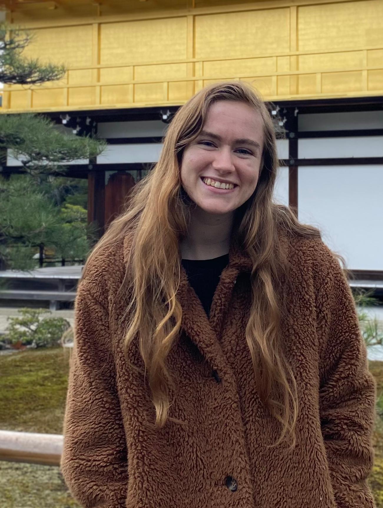 closeup of alumnus in front of Japanese temple