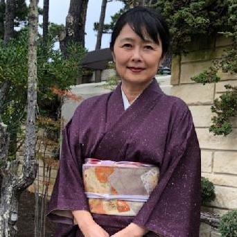 Woman in Japanese kimono standing in forest