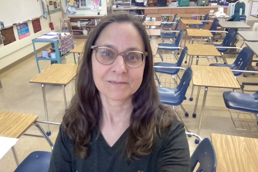 Woman posed with classroom behind