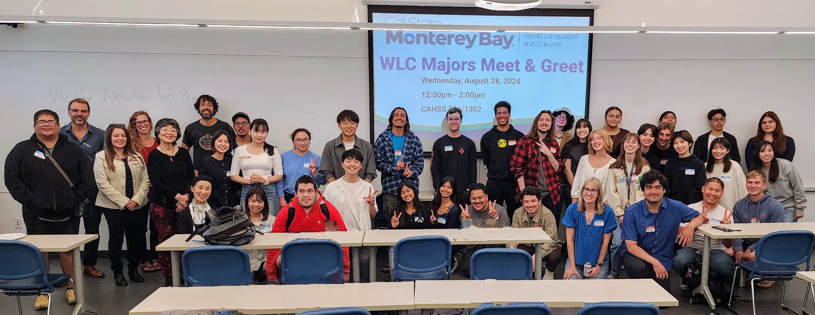 Students and Faculty pose at front of classroom