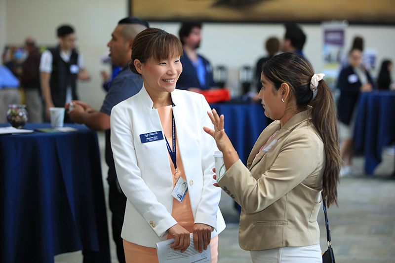 Assistant Professor Sharon Hua talking to accounting student