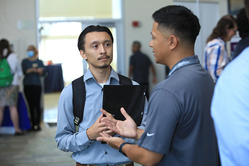 Accounting firm representative talking to accounting student at career fair