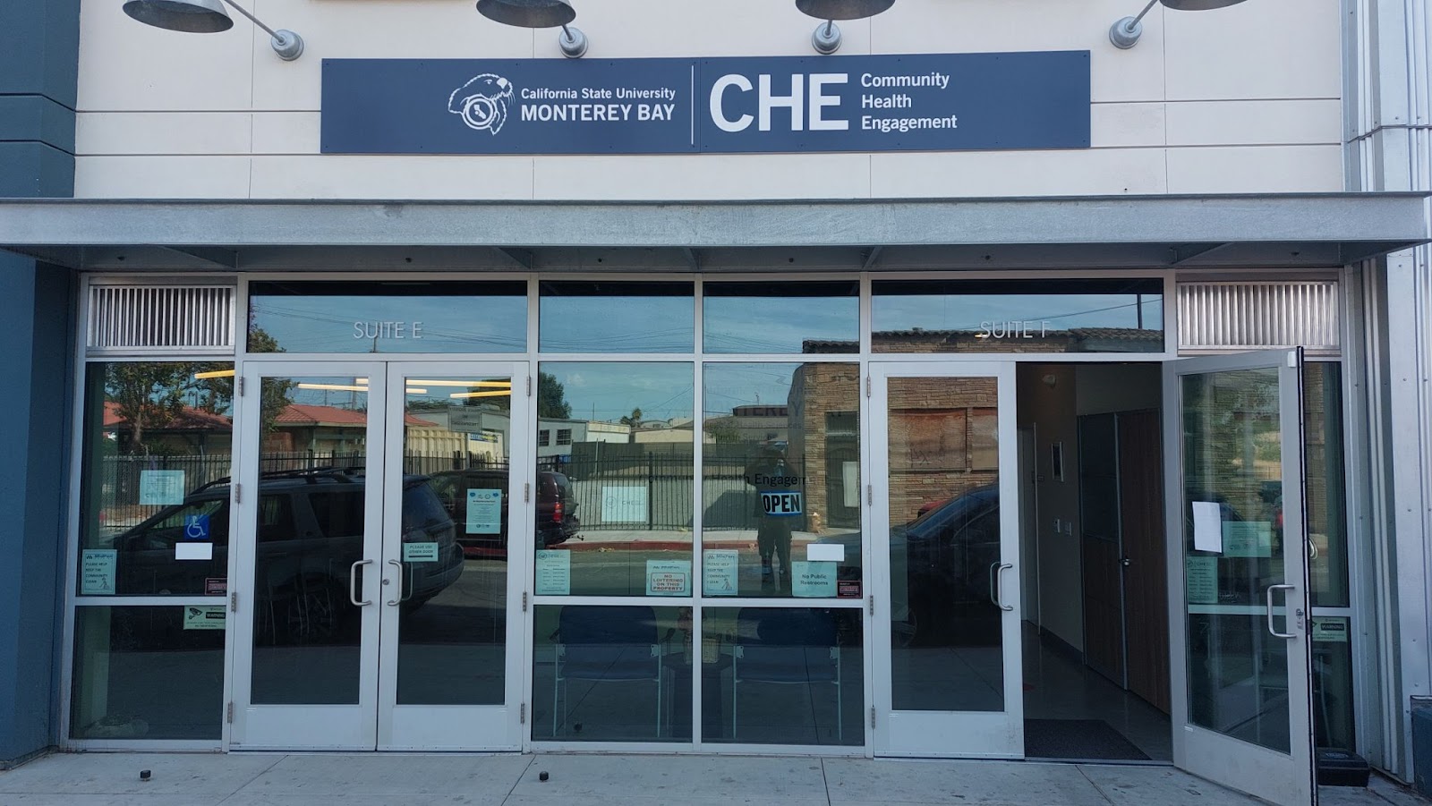 The main doors and storefront of CHE including CSUMB logos