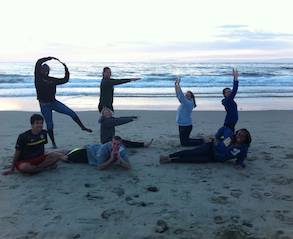 Students spelling out REU on the beach