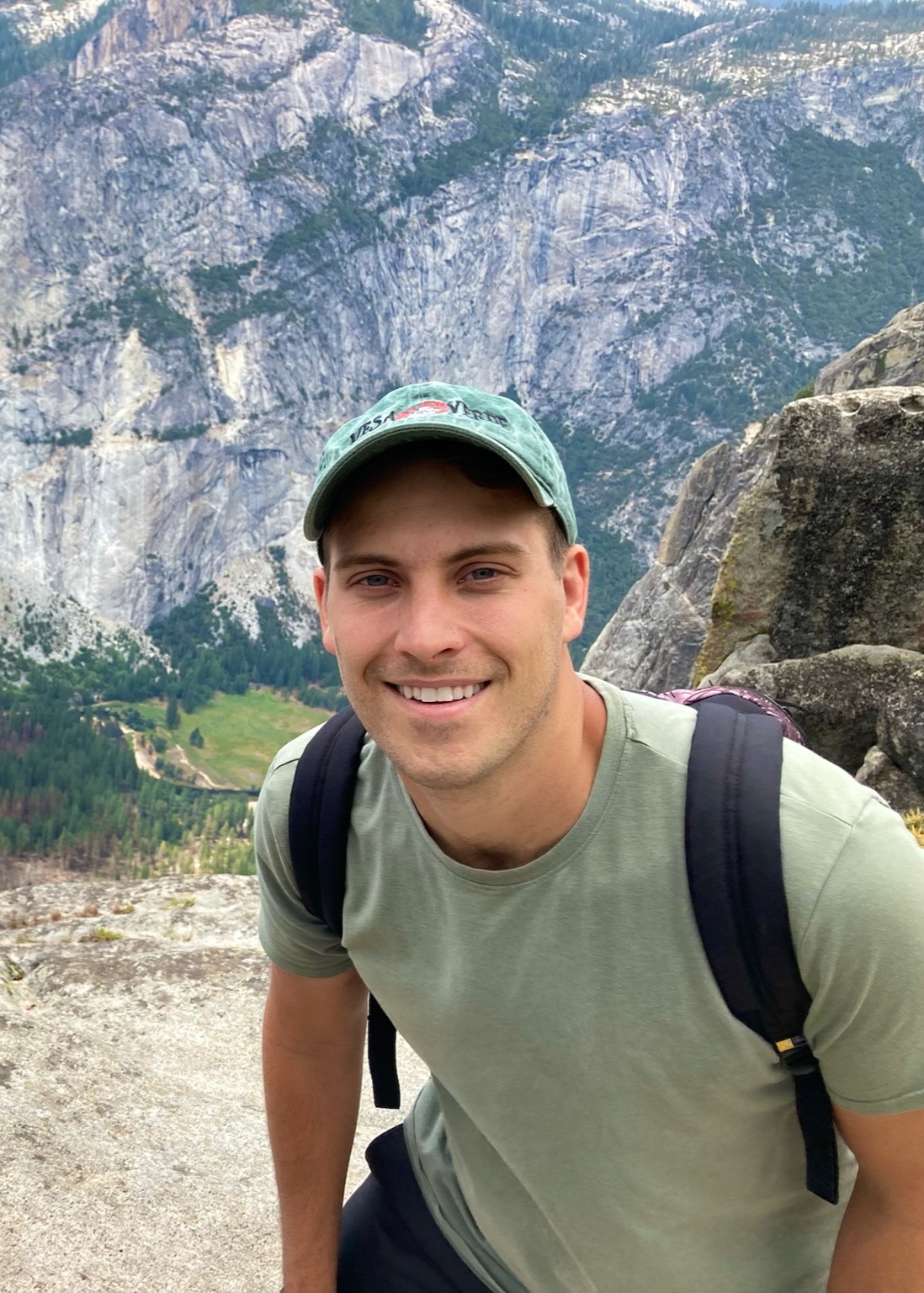 Bryan looking into the camera with mountains behind him