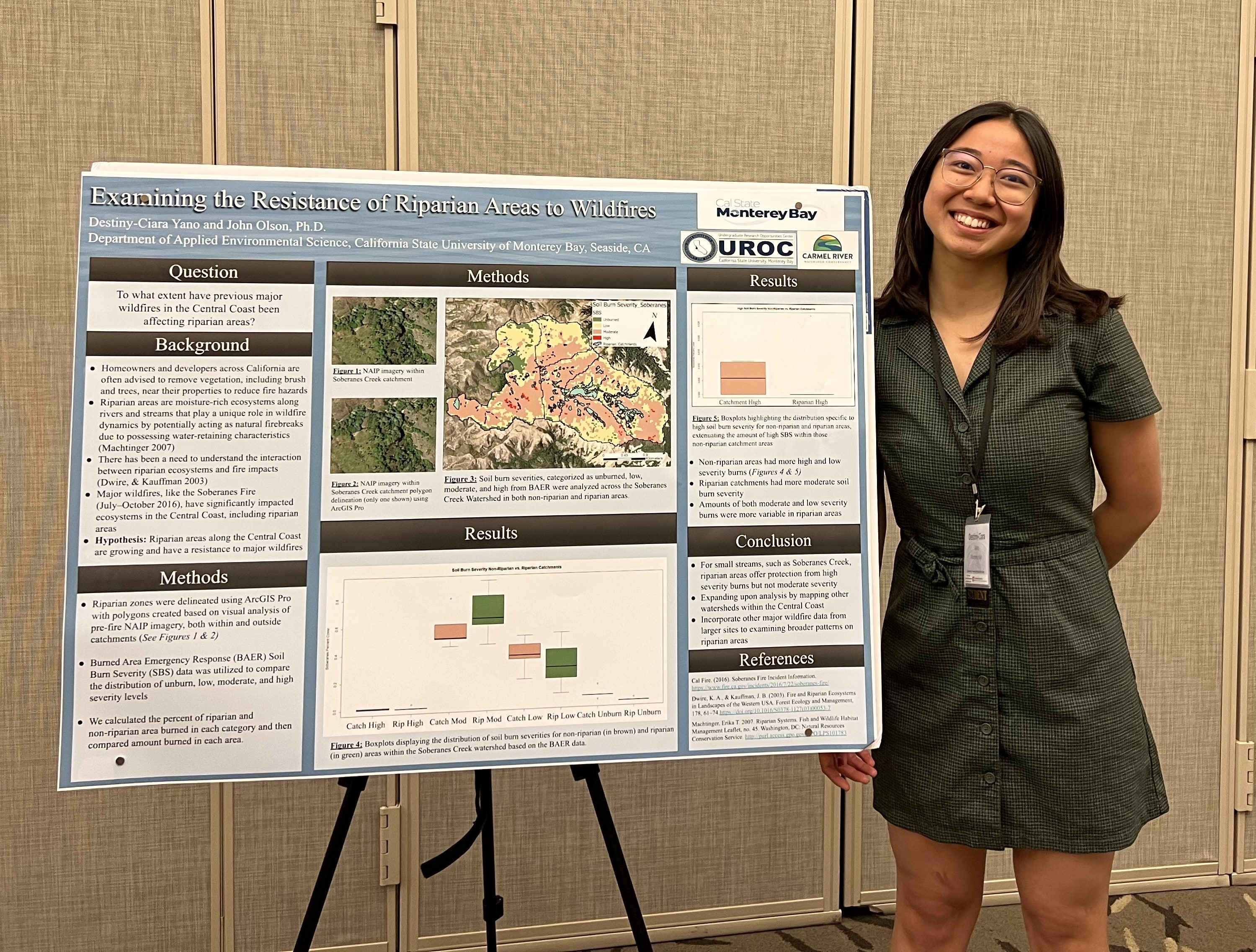 A woman standing next to an academic poster titled