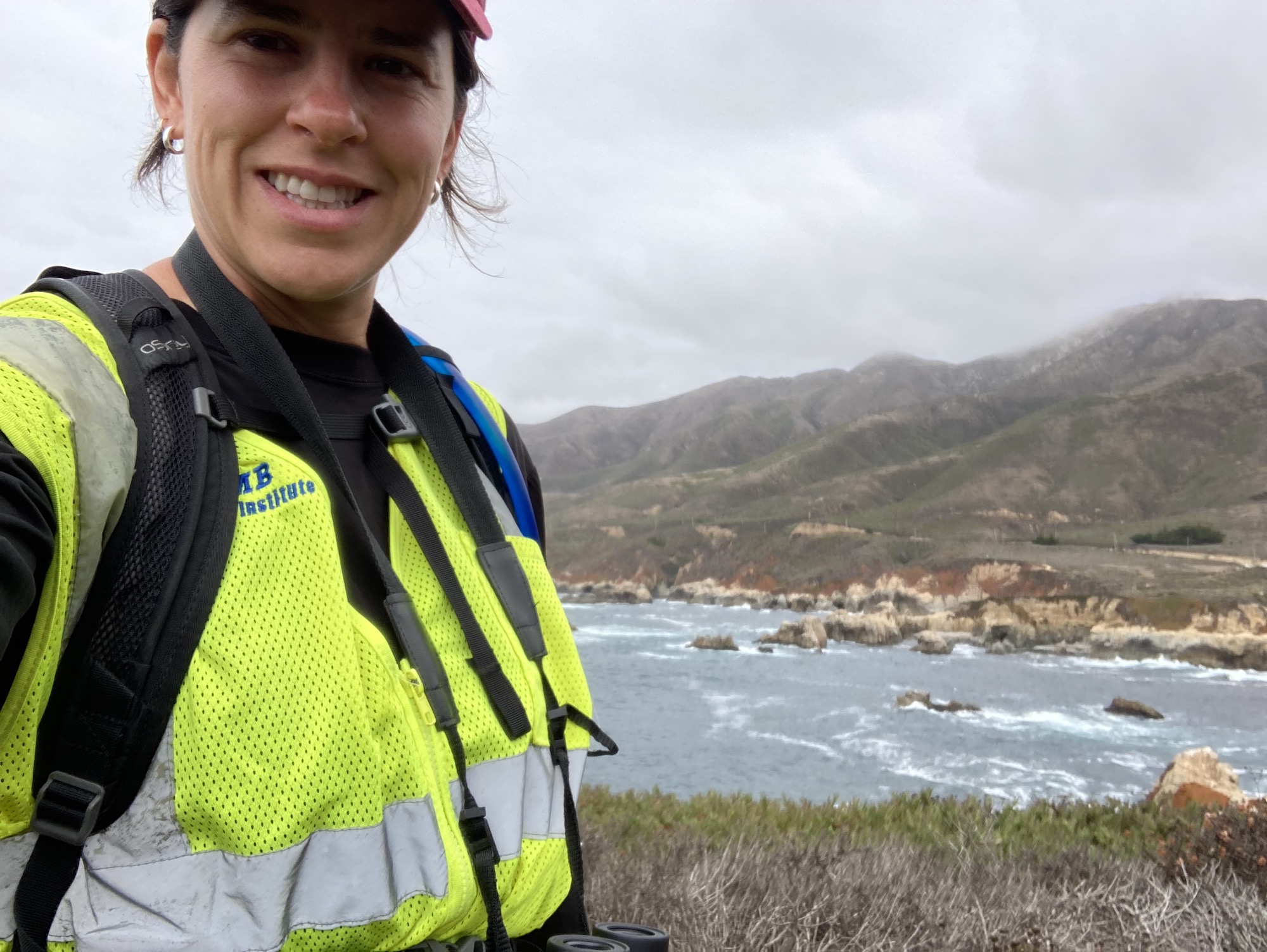 Michelle Tarian poses in front of the Big Sur coastline