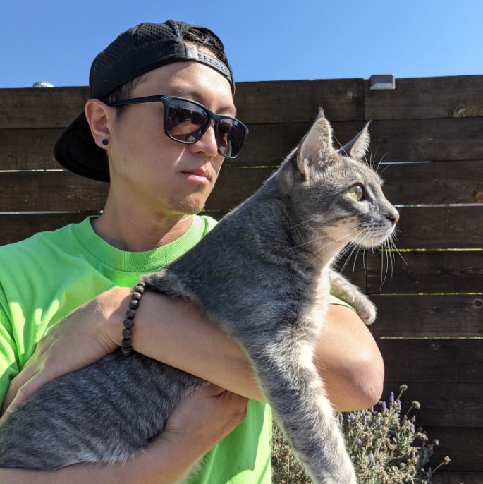 Michael Hang holds cat outdoors