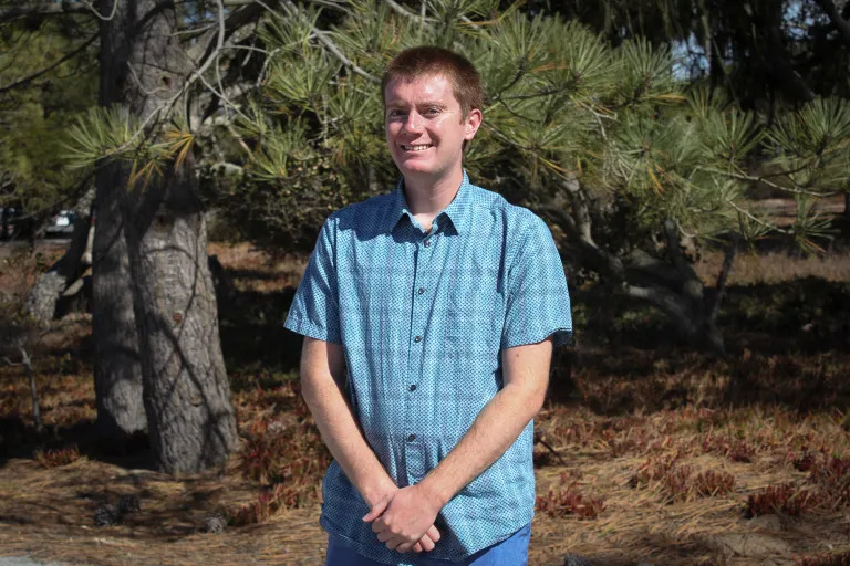 Ethan Quaranta stands in an outdoor setting