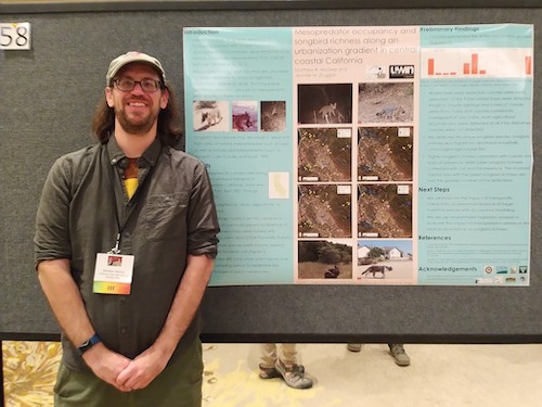 Matthew McGee poses with his poster at a conference
