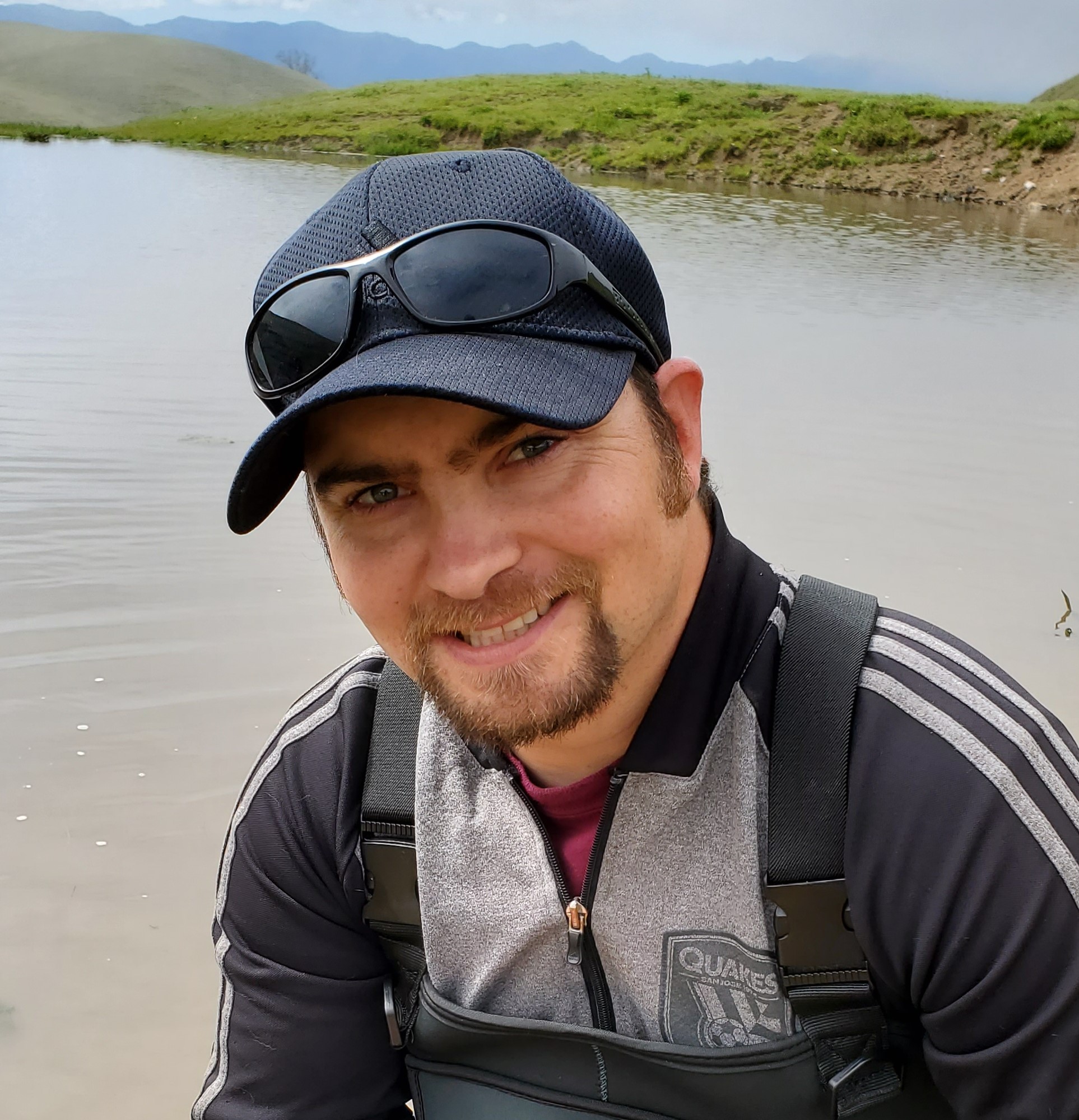Shawn Wagoner smiles in front of a wetland habitat