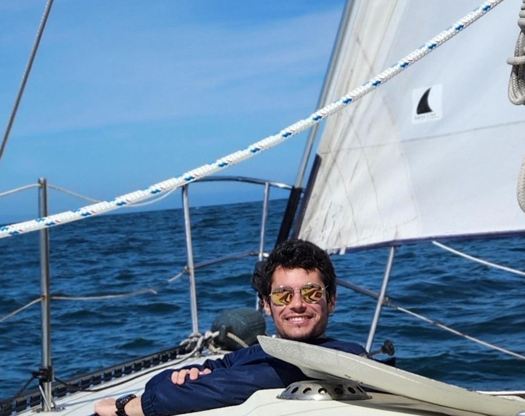 Gerhard smiling for the camera while sitting on a boat