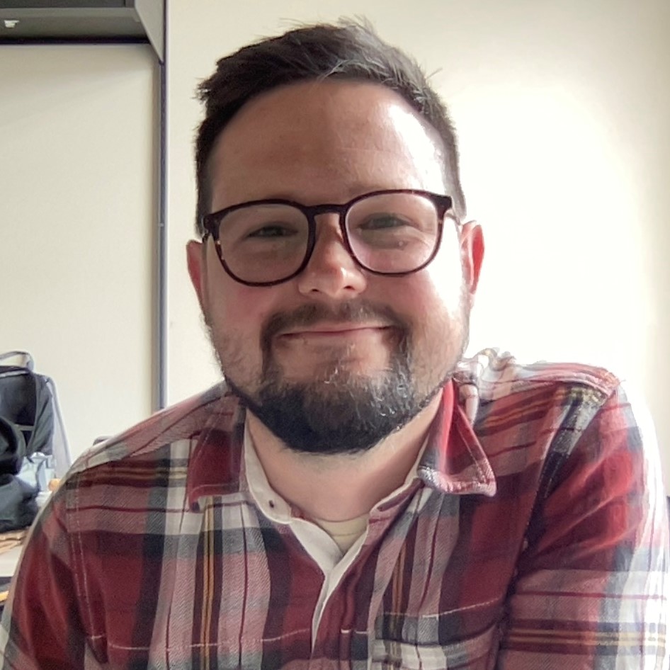 Seth Gustafson smiling in his office