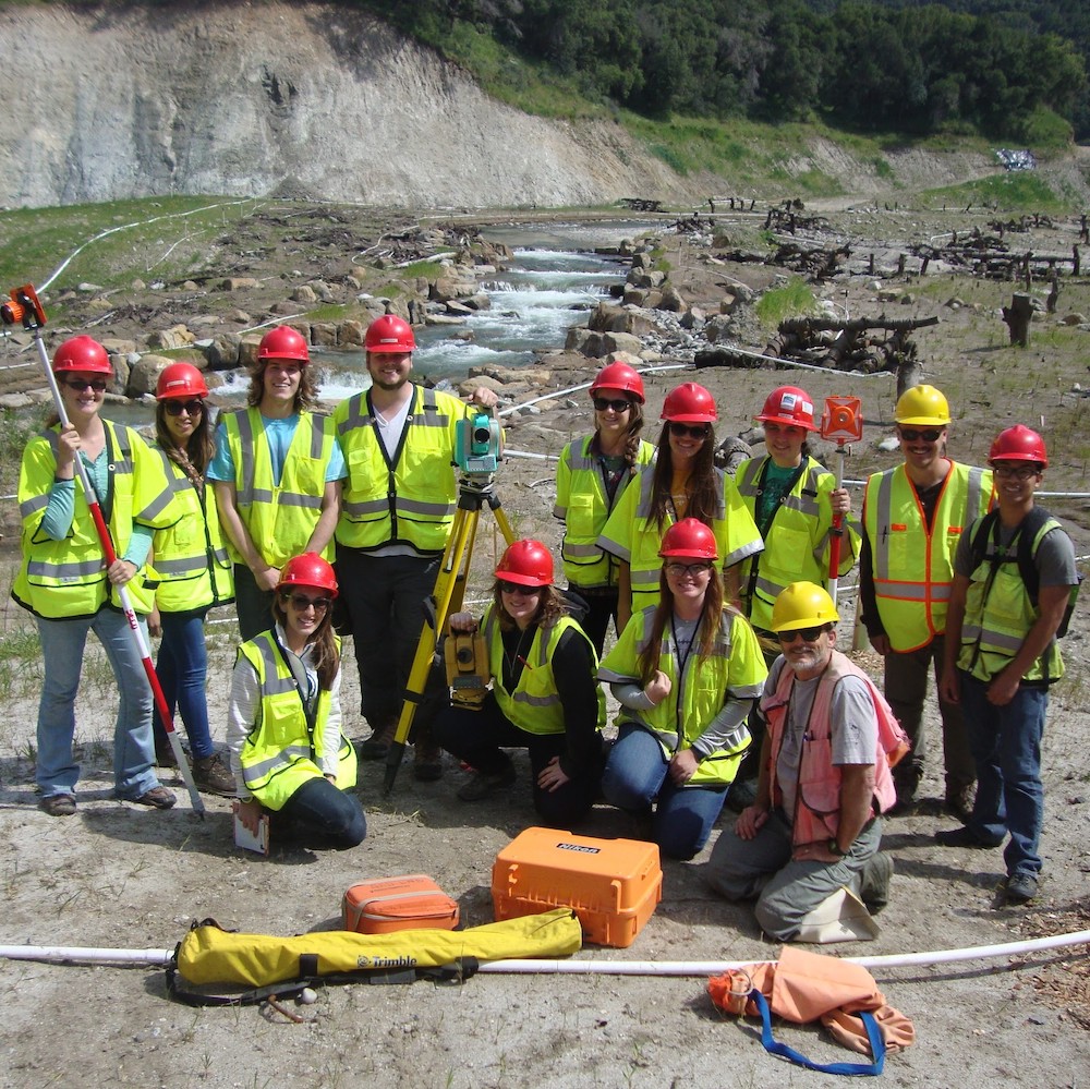 Environmental science undergraduate students on the site of a river restoration project