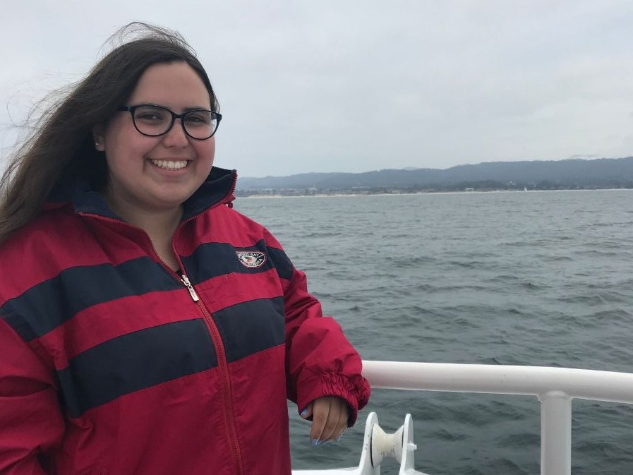 SIP student poses on a whale watching boat