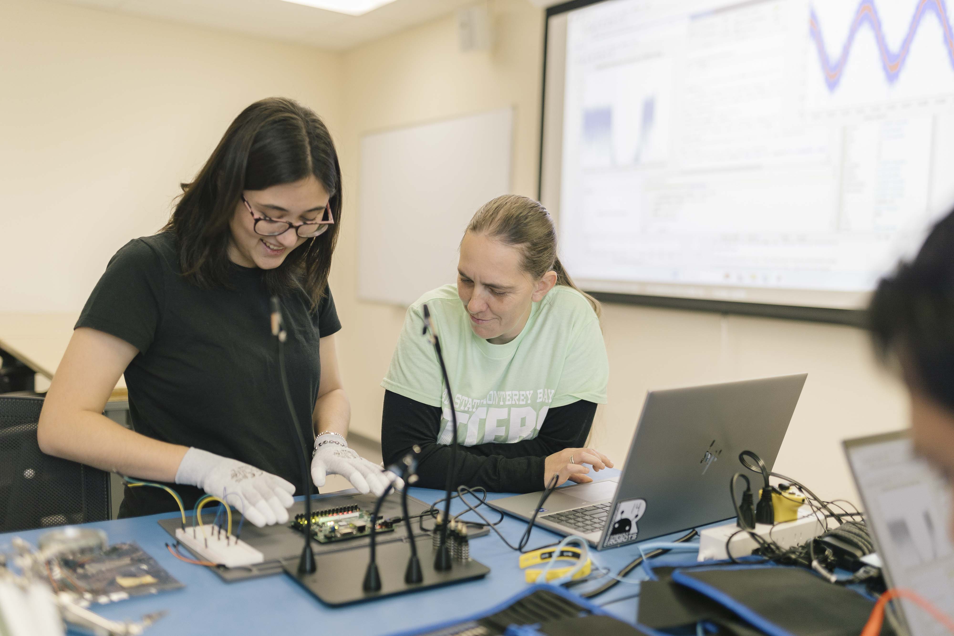 two college students working on a microcontroller