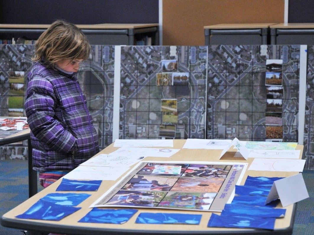 A student looks at educational materials on a table