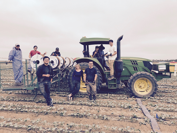 Students standing in front of tractor