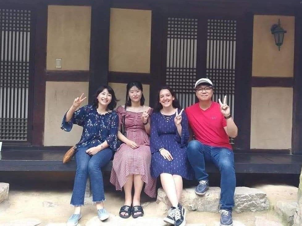 Leslie sitting with her Korean host family