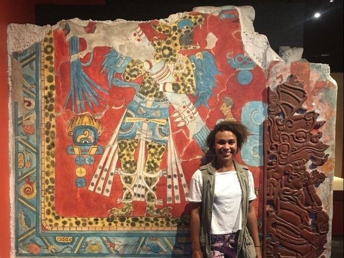 Celina in front of artwork at museum of anthropology