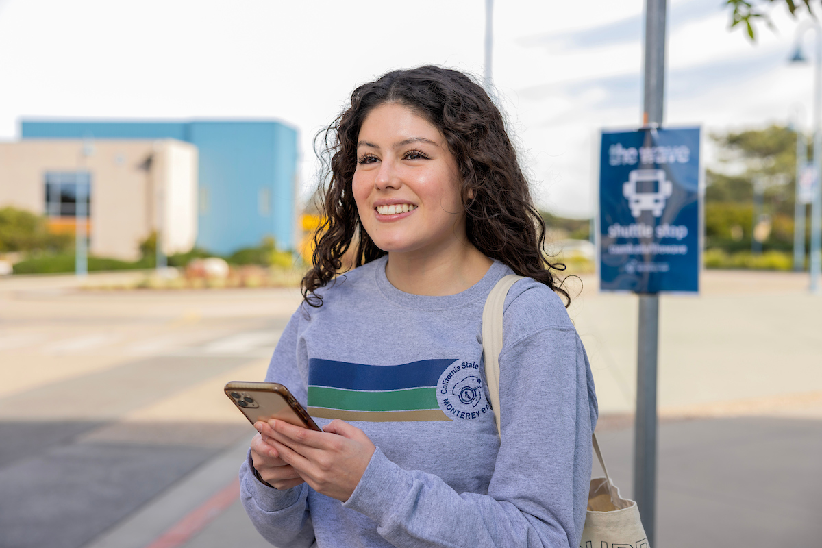 A girl using the Wave Tracker on her phone.