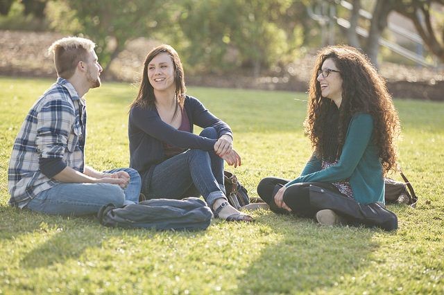 CSUMB students seated in grass