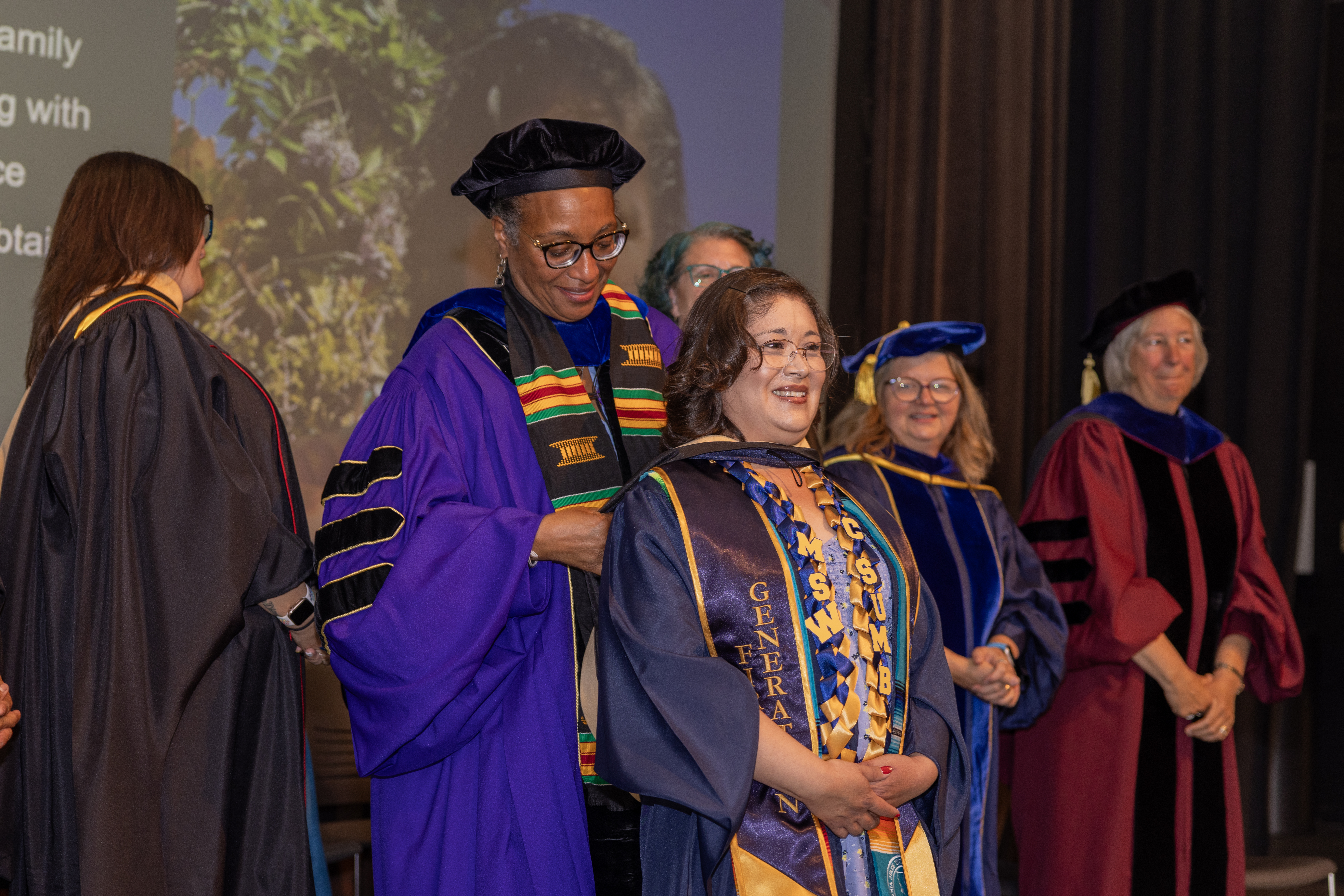 A MSW student getting hooded at their graduation