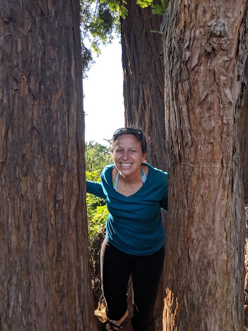 Photo of Robin Pelc smiling among redwoods